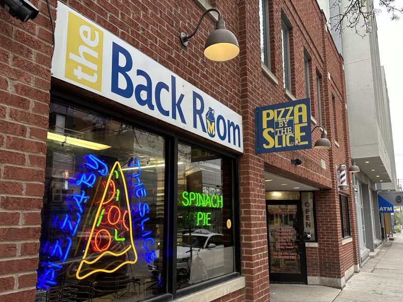 The Back Room displaying a neon pizza sign.