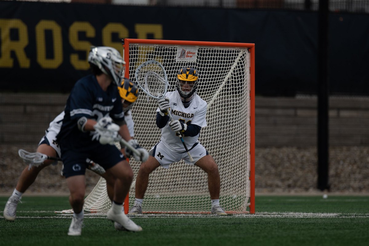 A Michigan goalie stands in front of the goal.
