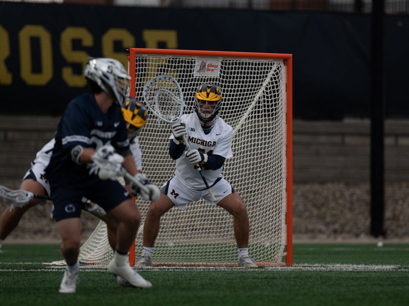 A Michigan goalie stands in front of the goal.