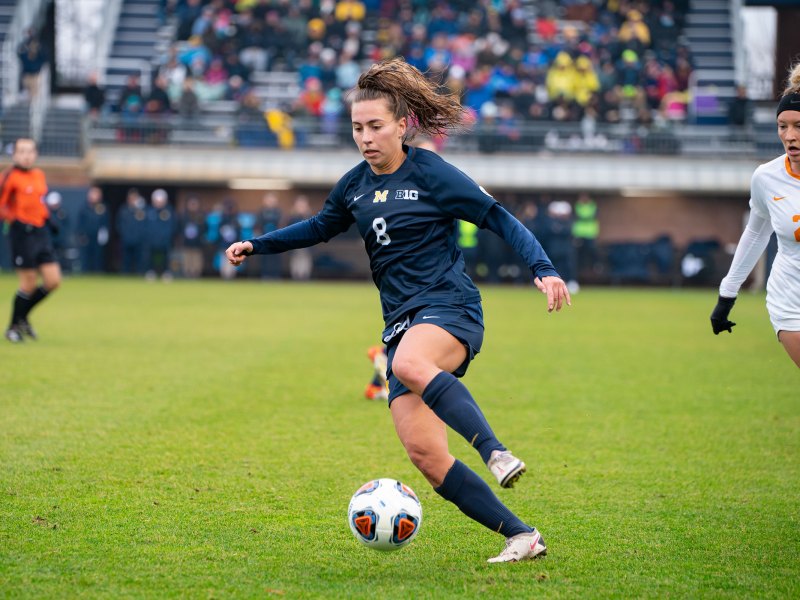 Taylor Brennan dribbles the ball on the field.