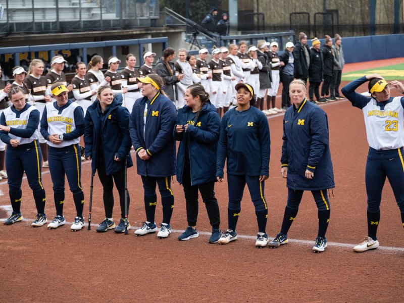 The UMich softball team lines up facing the crowd.