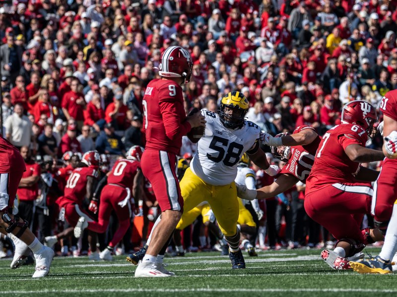 Mazi Smith runs for the Indiana quarterback as a lineman holds him back.