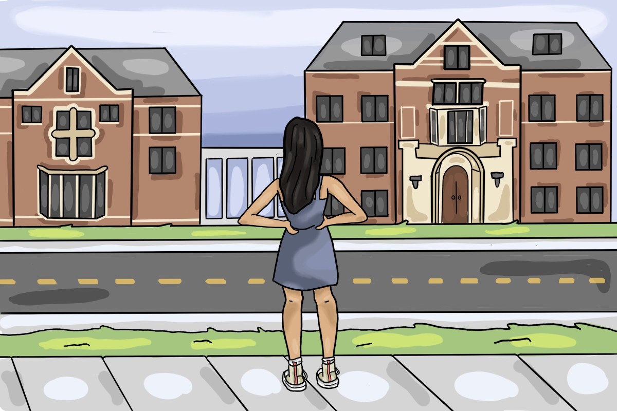 A girl standing on the sidewalk looking towards East Quad with her hands on her hips.